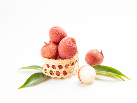 Fresh lychee fruit in basket isolated on a white background.の写真素材