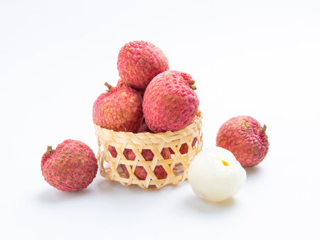 Fresh lychee in basket on white background. Litchi chinensisの写真素材
