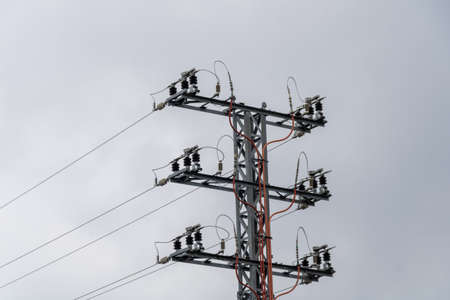 electricity tower on the mountain with cloudy skies in springの写真素材