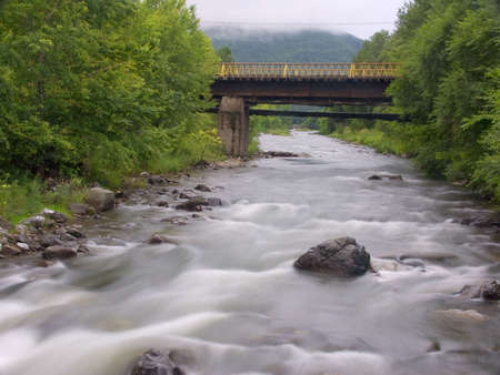 The old bridge through the river in Russia