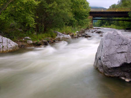The old bridge through the river in Russia
