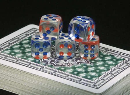 Playing cards and playing bones on a black backgroundのeditorial素材