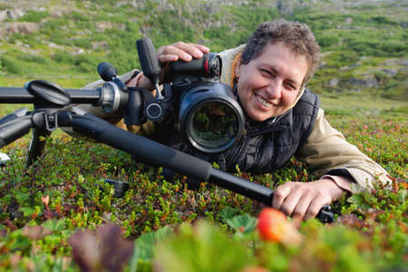 a woman with a camera photographing nature
