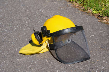 yellow construction helmet on the pavementの写真素材