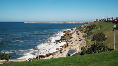 Coastal linear park, waterfront, stone breakwater skyの写真素材