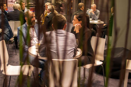 A man is walking while speaking on the phone at the convention trade center in Brno taking some time to have a coffee. BVV Brno Exhibition center. Czech Republicのeditorial素材