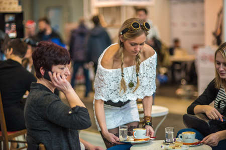 A waitress is serving coffee to a clients at the convention trade center in Brno. BVV Brno Exhibition center. Czech Republicのeditorial素材