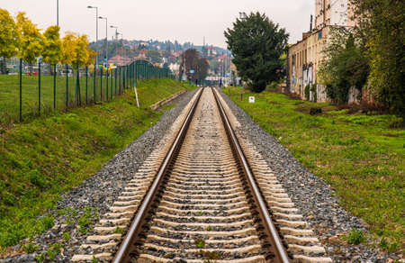 Old man with mask with walking stick crossing the train tracks in Pragueのeditorial素材