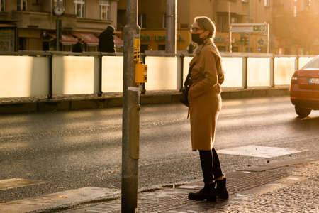 People with mask is crossing the street at Hradcanska metro station during quarantine period due to outbreak of COVID-19 as winter is starting. Prague, Czech Republicのeditorial素材