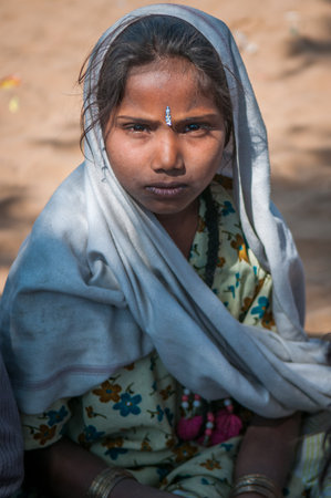 She live at an informal settlement in India where they collect rubber for income. Children with...