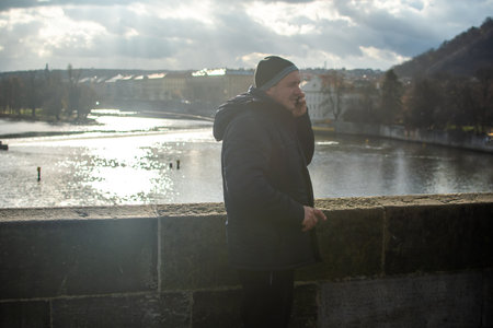 Editorial â December 15thPrague, Czech Republic. 01-11-2020. Tourists are walking on the Charles Bridge on the Historical town. Couple checking their cellphone on charles bridge.のeditorial素材