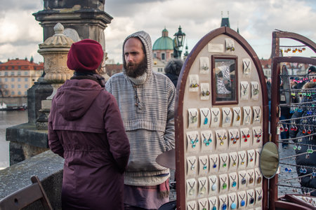 Editorial â December 15thPrague, Czech Republic. 01-11-2020. Tourists are walking on the Charles Bridge on the Historical town.Man selling on his gift shop at the charles bridge.のeditorial素材
