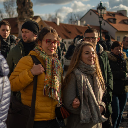 Prague, Czech Republic. 01-11-2020. Tourists are walking on the Charles Bridge on the Historical town in Prague. Two young women friends enjoying at the Charles Bridge in Prague.のeditorial素材