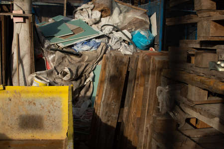 Rubbish from demolition. Construction pallets and rubbish. Construction site. Building is being reconstructed. Garbage as bricks, woods, metals, dust.の写真素材