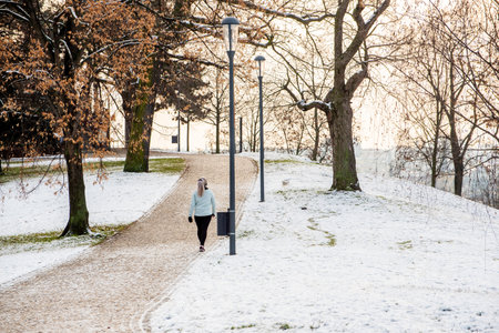 Prague, Czech Republic. 01-08-2021. People walking and running at Park Letna on the city of Prague during a snowing day, close to the Hradcanska metro station on Prague 6のeditorial素材