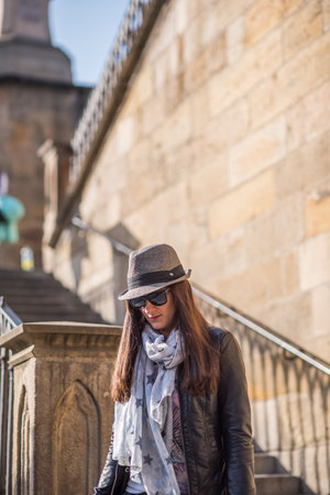 Prague, Czech Republic. 09-23-2019. Portrait of elegant young beautiful woman on the Charles Bridge during a sunny day in Prague.のeditorial素材