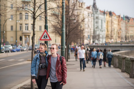 Prague, Czech Republic. 09-23-2019. Young beautiful couple walking close to the Charles Bridge during a sunny day in Prague.のeditorial素材