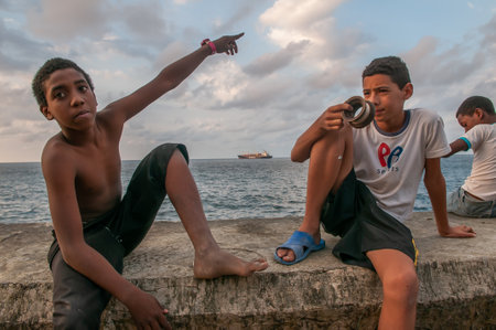 La Havana, Cuba. 04-15-2018. Two kids fishing at the Malecon with a sea view in La Havana, Cuba.のeditorial素材