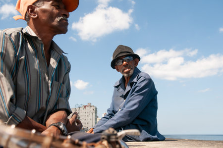 La Havana, Cuba. 04-15-2018. Portrait of an old man sitting at the Malecon with a sea view in La Havana, Cuba.のeditorial素材