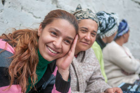Istanbul, Turkey. 05-23-2018. Muslim beautiful young smiling women sitting on a bench on the streets of Istanbul in Turkey.のeditorial素材