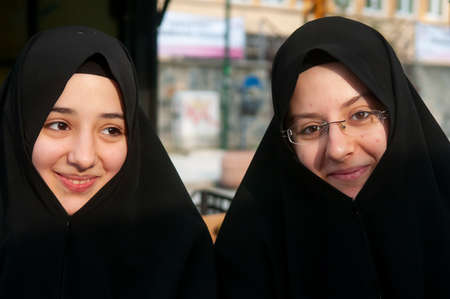 Istanbul, Turkey. 05-23-2018. Portrait of a two young muslim adolescents wearing the black dress abayat, on the streets of Istanbul in Turkey.のeditorial素材