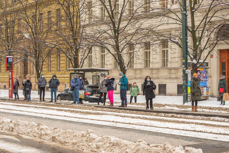 Prague, Czech Republic. 02-08-2021. People are are waiting for the tram in the city center of Prague on a cold winter snowy day.のeditorial素材
