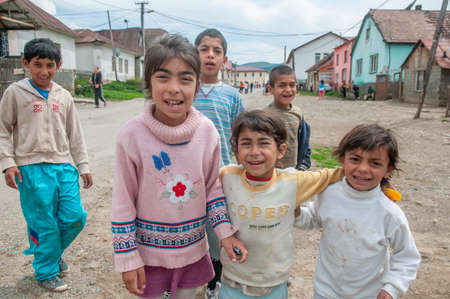 05-16-2018. Lomnicka, Slovakia. A close-up of a Roma or Gypsy group of children hugging and smiling in an abandoned community in the heart of Slovakia, living in miserable conditions.のeditorial素材