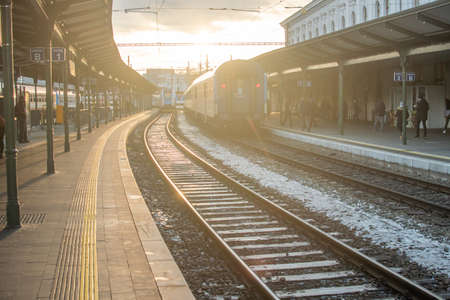 Brno, Czech Republic. 02-17-2021. Train at Halvni Nadrazi main tram station in the city center of Brno with beautiful sunset during a cold winter day.のeditorial素材