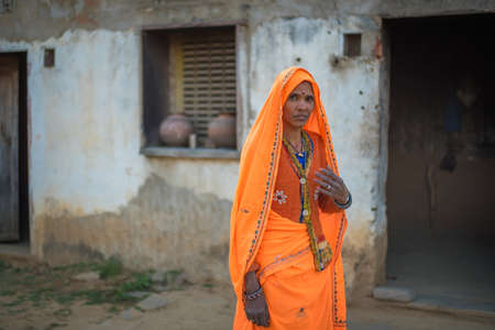 Rajasthan. India. 07-02-2018. Woman at her house in rural community. Women apart of taking care of children, they have an important role financial provider of their families.のeditorial素材