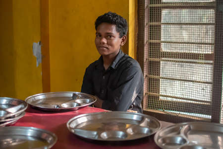 Uttar Pradesh. 05-15-2018. male adolescent after finishing lunch at school. Children has the opportunity of receiving quality education deprived for child that has to work to support families.のeditorial素材