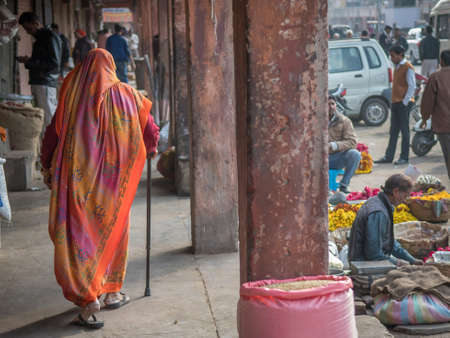 Jaipur, India. 09-05-2018. Old woman with stick is walking on the streets of Jaipur in the Rajasthan in the local market.のeditorial素材