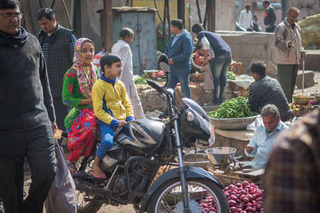 Jaipur, India. 09-05-2018. Mother and son are sitting in their motorcycle in the local market in the center of Jaipur.のeditorial素材