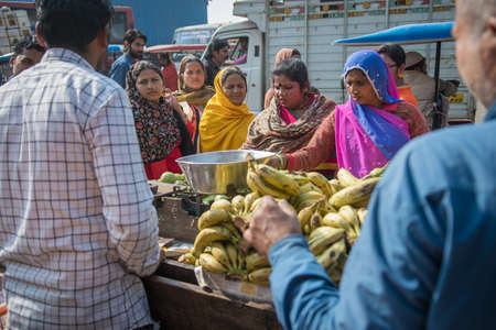 Jaipur, India. 09-05-2018. Plenty of women gathered at a street shop that is selling a variety of local fruits and vegetables in the market of Jaipur.のeditorial素材