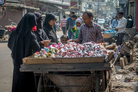 Jaipur, India. 09-05-2018. Women are buying bracelets from a man in the local market in the center...