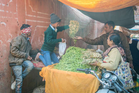 Jaipur, India. 09-05-2018. A couple is buying vegetables from a teenager in the local market in the...