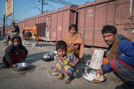 Varanasi. India. 11-02-2018. A family having breakfast at the Varanasi train station.のeditorial素材