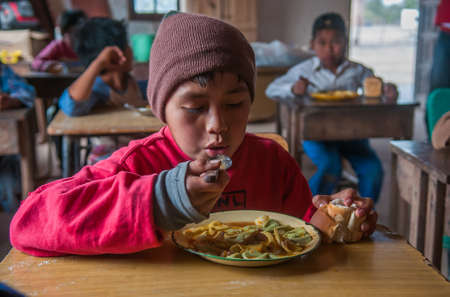 Chaco Province. Argentine. 15-01-2019. Portrait of an indigenous boy having lunch while attending school in the Chaco Province, North of Argentine.のeditorial素材