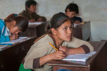 Chaco Province. Argentine. 15-01-2019. Portrait of an indigenous girl writing in her notebook while attending school in the Chaco Province, North of Argentine.のeditorial素材