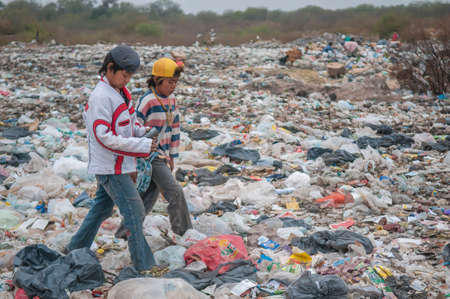 Chaco Province. Argentine. Two Indigenous boys are collecting plastic and other recycle materials at a garbage dump, to sell them at a profit.のeditorial素材