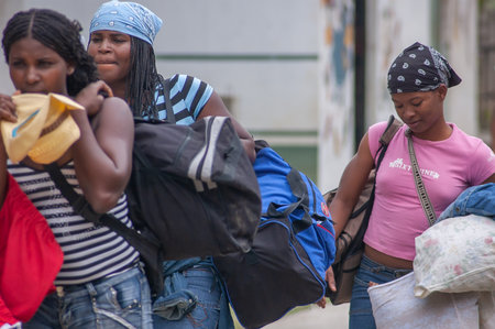 Darien Province, Panama. 07-18-2019. Indigenous migrant women arriving to Yaviza and are waiting for...
