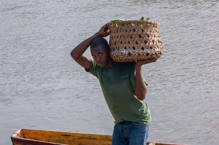 Darien Province, Panama. 07-18-2019. Indigenous young adolescent working on the port of Yaviza...