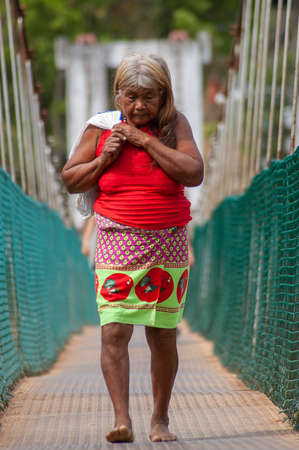 Darien Province, Panama. 07-18-2019. Indigenous old lady crossing the bridge in Yaviza in the Darien Province of Panama.のeditorial素材