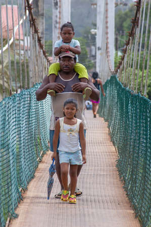 Darien Province, Panama. 07-18-2019. An afro-descendent family crossing the bridge in Yaviza in the Darien Province of Panama.のeditorial素材