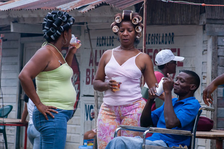 Darien Province, Panama. 07-18-2019. Two Afro-descendent women speaking with a handicap male in the Darien Province, Panama, Central America,のeditorial素材