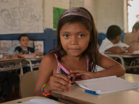 Suchitoto, El Salvador. 03-18-2019. Portrait of a girl at school writing in the classroom in the old town of Suchitoto.のeditorial素材