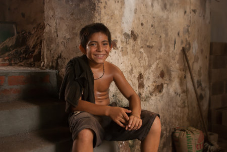 Suchitoto, El Salvador. 03-18-2019. Portrait of a sweaty boy after a hard fisically working day in Suchitoto.のeditorial素材