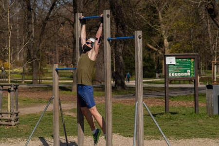 Prague, Czech Republic. 03-11-2020. Young man working out in Park Stromovka. COVID-19 it is a world spread pandemia affecting the whole world.のeditorial素材