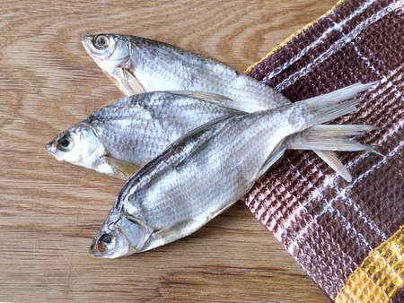 Taranco on the table with a towel three fishes great though, and easy treat great salt roach a delicious dinnerの写真素材