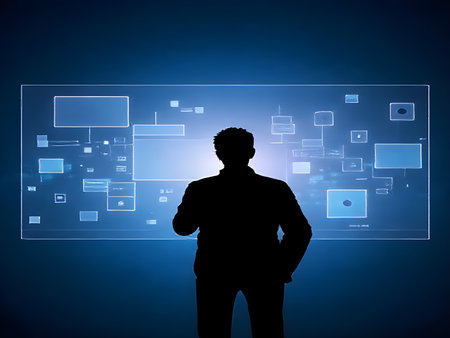 Silhouette of businessman working with virtual panel on dark blue backgroundの素材