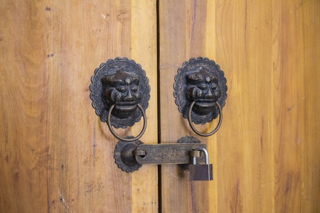 Lion head door knocker on the wood doorの写真素材